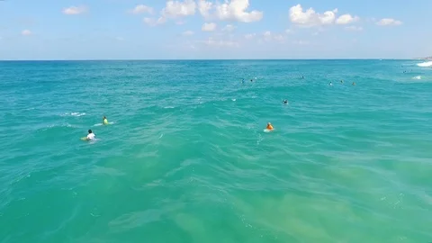 Drone shot of Surfers catching waves Stock Footage 89927796