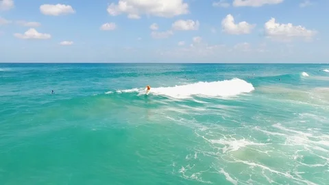 Drone shot of Surfers catching waves Stock Footage 89927945