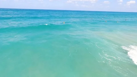 Drone shot of Surfers catching waves Stock Footage 89930025
