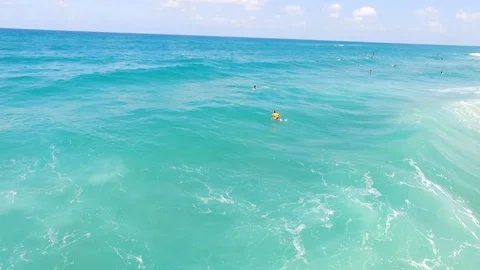 Drone shot of Surfers catching waves Stock Footage 89930171