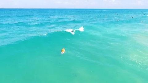 Drone shot of Surfers catching waves Stock Footage 89930251