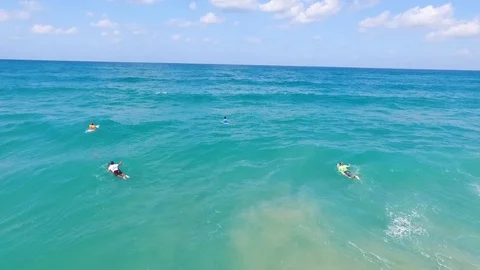 Drone shot of Surfers catching waves Vídeo Stock 89930270