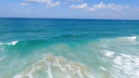 Drone shot of Surfers catching waves Stock Footage 89930450