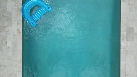 Drone shot of swimming pool with float Stock Footage 308421690