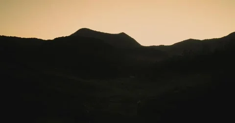 Drone Shot of Tea Plantation with Dramatic Light and Shadow during Foggy Morning Stock Footage 333629196