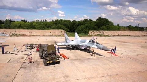 Drone shot of technical service inspecting military fighters MIG-29 after Stock Footage 73481229