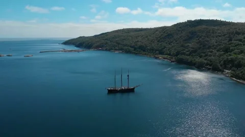 Drone shot of a three masted schooner in a fjord at summer Video stock 236471717