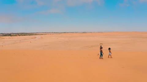 Drone Shot of three people walking in desert in Namibia Stock-Footage 170367240