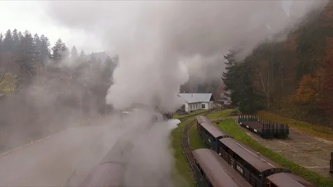 Drone shot through the smoke of the old train in the mountains Stock Footage 124076741