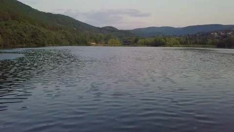 Drone shot Tilt Up From Water Surface to Forest Mountain View Stock Footage 159534399