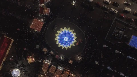 Drone shot: Top down shot of huge christmas tree from above with lights on. Stock Footage 93847938
