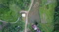 Drone shot top view aerial follow footpath jungle mountain village buildings 4k or 4k+ Resolution