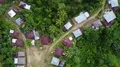 Drone shot top view aerial flight from jungle mountain village to graveyard 4k or 4k+ Resolution