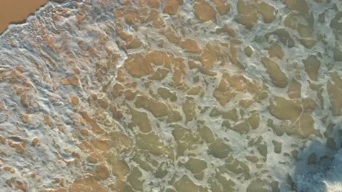 Drone shot top view over ocean waves and sand beach Stock Footage 130515547