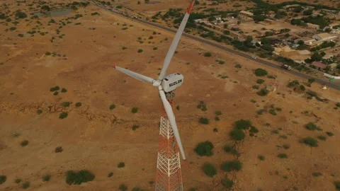 A drone shot from the top of  windmills working in a desert in Jaisalmer, India Stock Footage 251512358