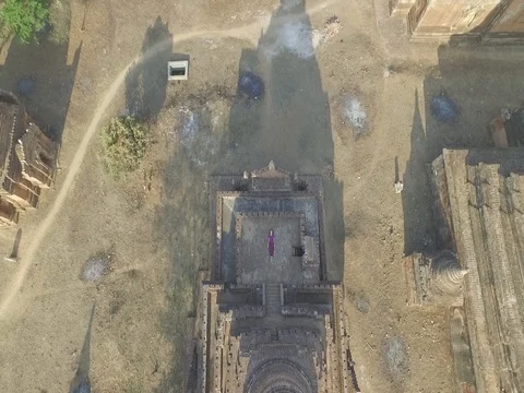 Drone shot: Topdown on Bagan temple with girl in beautiful purple outfit Stock Footage 81797083