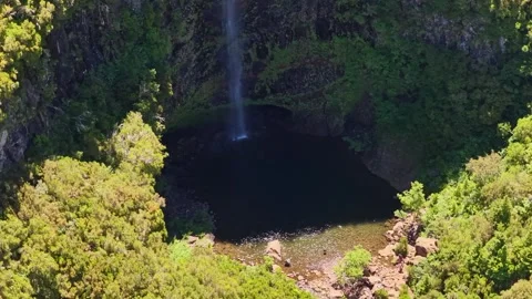 Drone Shot of Tourists at Risco Waterfall Lagoon in Madeiran Laurel Forest 스톡 동영상 345019650