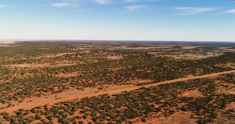 Drone shot tracking backwards over the red earth of the outback. Stock Footage 93115802