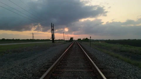 Drone Shot Tracking Backwards Over Empty Railroad Tracks At Sunset In Stock Footage 188436966
