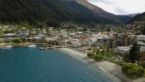 Drone shot tracking down to Queenstown beach Stock Footage 90267352