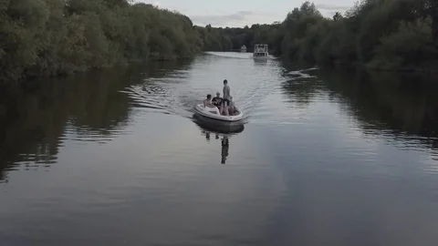 Drone Shot Tracking group of men in boat on beautiful river summer time HD Stock Footage 128043337