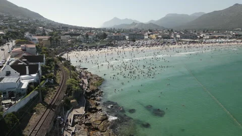 Drone Shot Tracking Over Busy Fish Hoek Beach with Thousands of Visitors 스톡 동영상 296375178