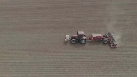 Drone shot of a tractor sowing rapeseed in the field Stock Footage 159805857