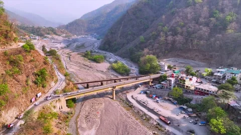 Drone shot of traffic moveing on flyover and dry river in shivpuri rishikash Stock Footage 309634706