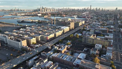 Drone shot of traffic passing through Brooklyn at sunrise Stock Footage 253876345