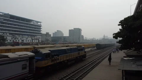 Drone Shot of Train Arriving at Station in Dhaka with Person Sitting on Roof Video stock 327359736