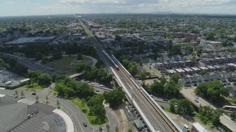 Drone Shot of Train Passing Through Train Station at Belmont Park UBS Arena, NY Video stock 235504426