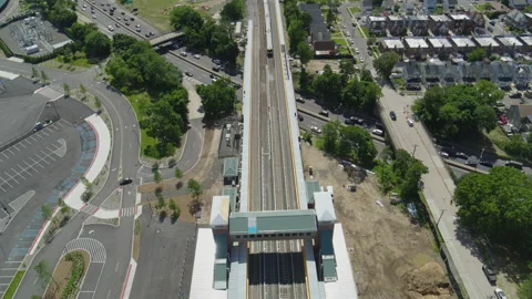 Drone Shot of Train Passing Through Train Station at Belmont Park UBS Arena, NY Stock Footage 237203682