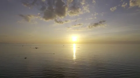 A drone shot of a tranquil sunset over calm waters with reflectin Stock Footage 319846670