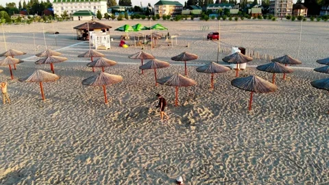 Drone shot of a treasure hunter on the beach looking for treasure Stock Footage 169093543