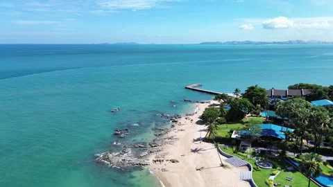 Drone shot of a tropical beach with clear blue water and lush greenery, perfect  Stock Footage 278299511
