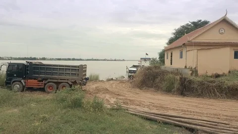 Drone shot : Trucks driving in reverse inside a small ferry vessel Stock Footage 97704251