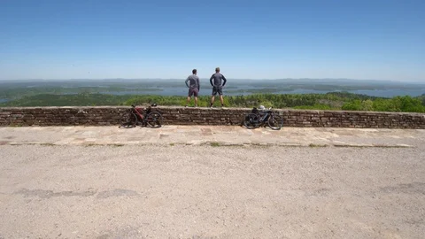 Drone Shot of Two Bikers Standing on Edge of Windy Cliff, Wide Stock Footage 95944728