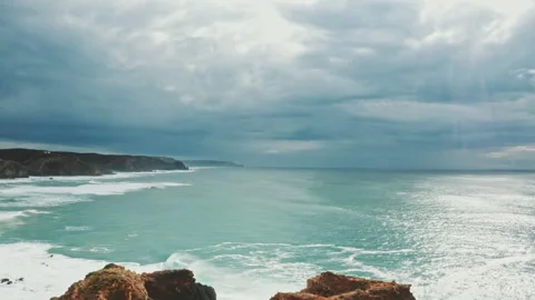 Drone shot of two men standing on the top of the cliff Stock Footage 203597109