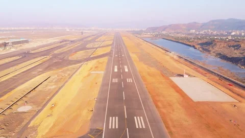 Drone shot a under construction runway with lake alongside Stock Footage 300960875