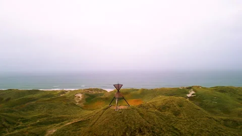 Drone shot of unlighted beacon seamark in dunes Stock Footage 288573277