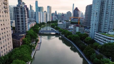 Drone Shot of an Urban River Arch Bridge and High-Rise Buildings Shanghai China Stock Footage 346334443