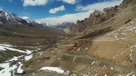 Drone shot of vehicle crawling through a surreal landscape of white peaks and Stock Footage 310807049