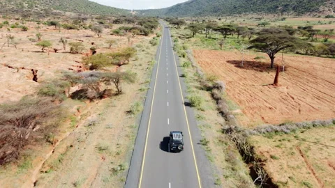 Drone shot of vehicle driving through African savanna. Stock Footage 225968148