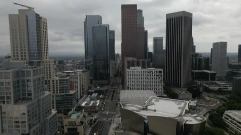 Drone shot view through downtown Los Angeles with empty roads and tall skyscrape Stock Footage 220088622