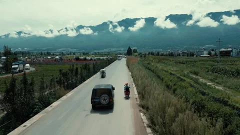 Drone Shot View of a Young Couple Riding a Scooter on the Mountain Road 4K Stock Footage 247997311
