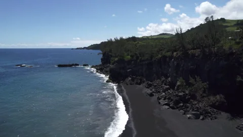 Drone Shot of Volcanic Cliffs and Black Sand Beach on La Réunion Coast Stock Footage 315372513