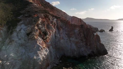 Drone Shot of Volcanic Cliffs and Sea Stacks near Plathiena Beach Milos, 4K Stock Footage 337174842
