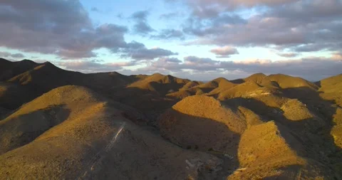 Drone shot of Volcanic Mountain Range in Magdalena Bay Mexico at Sunrise Stock Footage 334638624