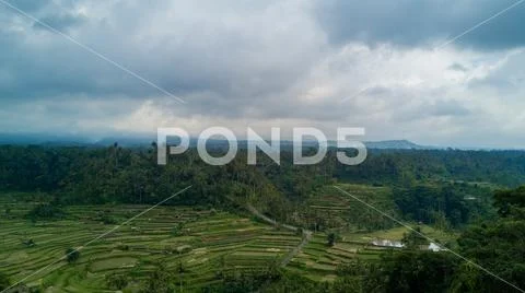 Drone shot volcano Mount Agung with rice fields foreground in Bali Stock Photos