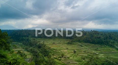 Drone shot volcano Mount Agung with rice fields foreground in Bali Stock Photos